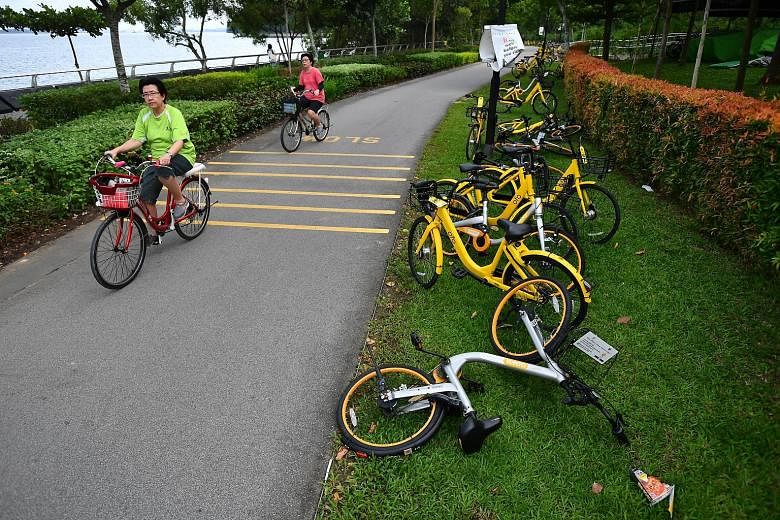 Abandoned rental bikes near The Punggol Settlement last month. Such incidents have led to a push by the authorities and bike-sharing firms to "encourage responsible operation of bicycle-sharing services in public spaces".