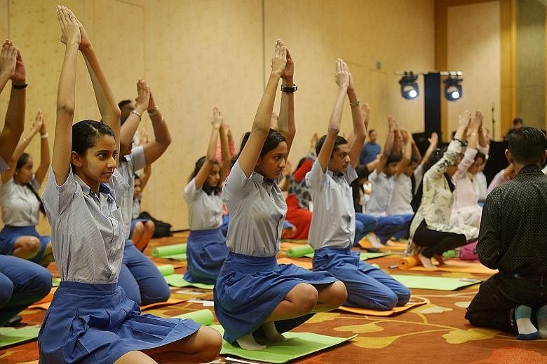 Students from the Global Indian International School doing Yoga Namaskar, a form of Upa Yoga taught by the Isha Yoga school. This was one of the events on the sidelines of the Asean-India Convention at the Marina Bay Sands Convention Centre yesterday