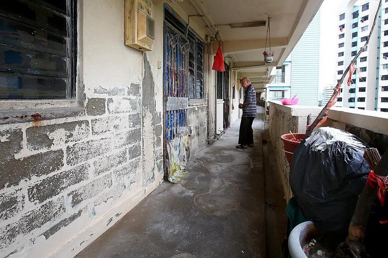 At Block 55, Lorong 5 Toa Payoh, where a woman was reportedly shouting loudly every morning. The walls outside her unit (left) were peeling, with bare bricks exposed at certain spots. The metal pipes were corroded and the floor looked pitted.