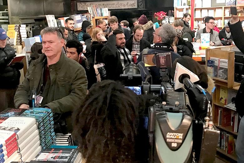 Customers lining up at Kramerbooks late on Thursday for the midnight sale of Fire and Fury: Inside the Trump White House by Michael Wolff. Journalists also turned out in large numbers.