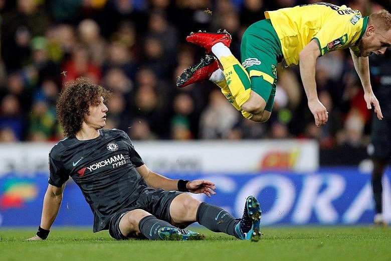 Norwich's Alex Pritchard is sent flying by this challenge from Chelsea's David Luiz in their FA Cup match on Sunday at Carrow Road. The Blues central defender has fallen behind Andreas Christensen in the pecking order this season and was selected for