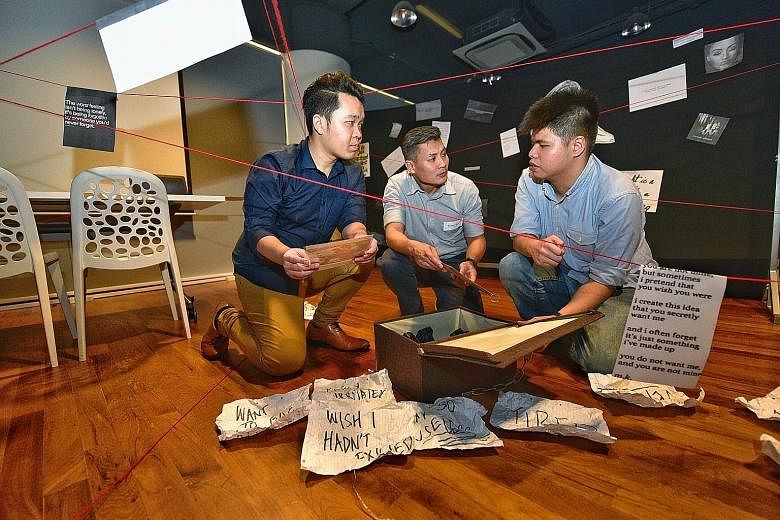 (From left) Game organiser and Youth Corps Singapore leader Cho Ming Xiu, National Youth Council chief executive officer David Chua and Mr Chia Xun An, who has suffered from depression and was diagnosed with borderline personality disorder, checking 