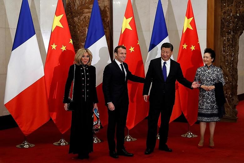 (From left) Mrs Brigitte Macron and French President Emmanuel Macron, who began his first state visit to China with a stop in Xi'an, with Chinese President Xi Jinping and his wife Peng Liyuan in Beijing yesterday.