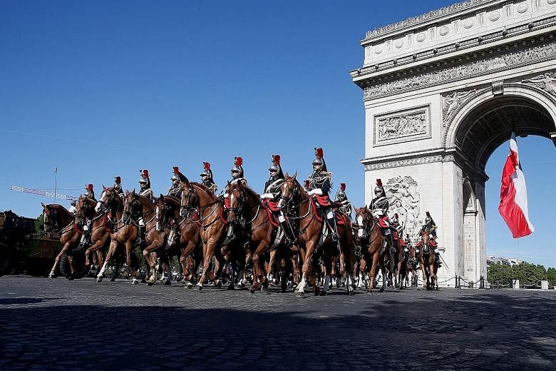 French Republican Guards on horseback during the Bastille Day military parade on the Champs-Elysees in Paris last year.