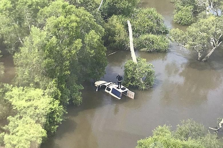 Most police officers are used to dealing with dangerous situations on the job, but one from Australia found himself needing to be rescued when he became stranded in crocodile-infested floodwaters in the Northern Territory yesterday. According to a Fa