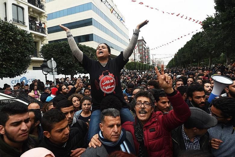 Tunisians demonstrating against the government and price hikes yesterday. Protests hit several parts of Tunisia where dozens of people were arrested and one man died in unclear circumstances amid anger over rising prices, the authorities said.