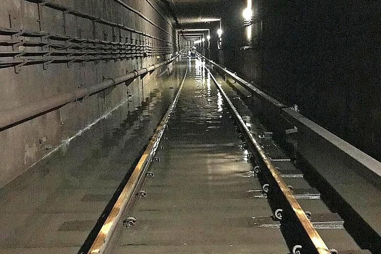 Officers from the Singapore Civil Defence Force, PUB, LTA and SMRT worked through the night on Oct 7 last year to clear the water in the tunnel between Bishan and Braddell stations.