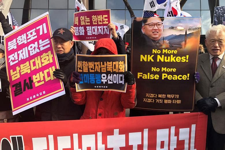 Members of conservative groups, who are against holding inter-Korean talks without the North abandoning its nuclear programme, at a rally in Seoul yesterday.