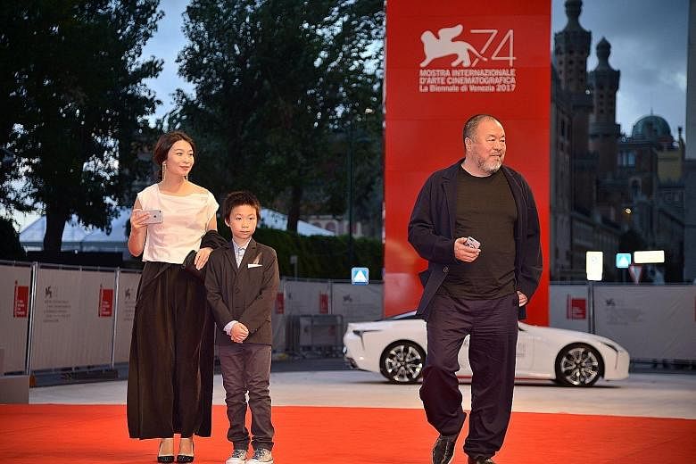 Chinese artist Ai Weiwei arriving with his wife Lu Qing and son at the premiere of his movie Human Flow presented in competition at the Venice Film Festival last year.