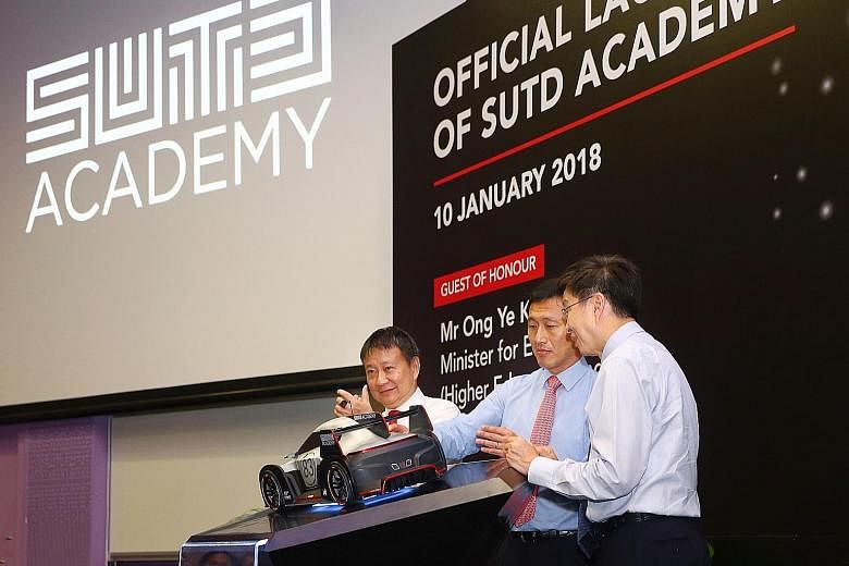 From far left: SUTD chairman Lee Tzu Yang, Education Minister (Higher Education and Skills) Ong Ye Kung and the university's acting president and provost Chong Tow Chong pressing a touchpad to officially launch SUTD Academy yesterday. The academy wil