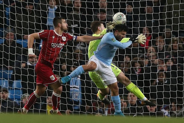 Manchester City's Sergio Aguero heading in the last-gasp winner as City take a 2-1 advantage in the first leg of the League Cup semi-final. The second leg will be played on Jan 23.