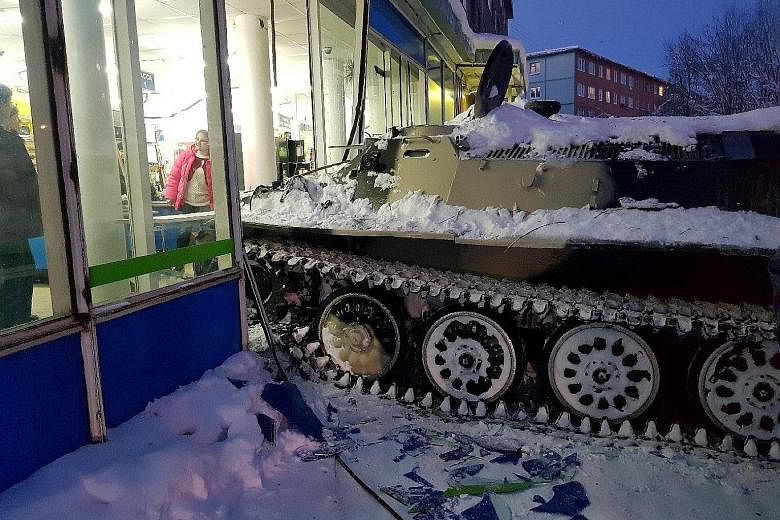 The scene of the incident at the shop in the town of Apatity, Russia, on Wednesday. The man had swiped the vehicle from a privately run motorsport training ground nearby, and driven it through a forest and into the small town just south of the Arctic