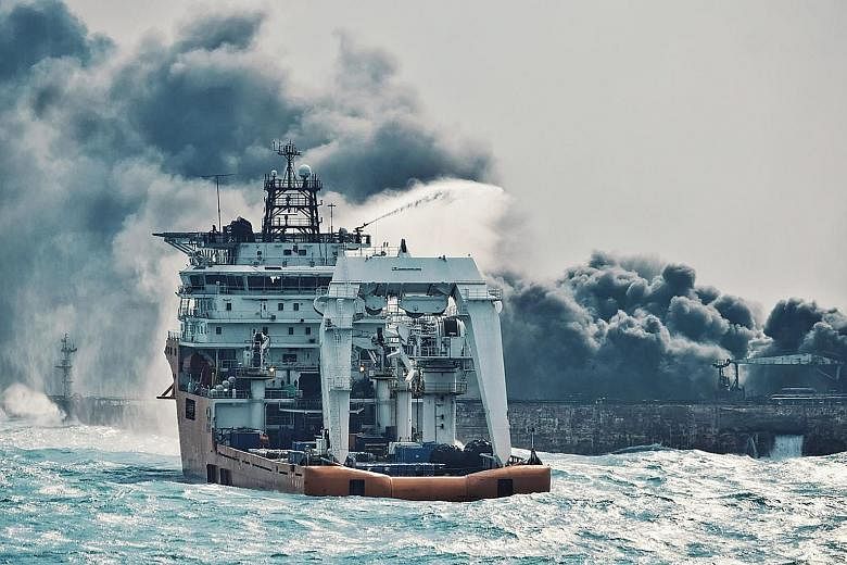 A Chinese offshore supply ship spraying foam on the burning Sanchi oil tanker off the coast of eastern China on Wednesday. The Iranian tanker, which collided with a freight ship and burst into flames last Saturday, remains at risk of exploding and si