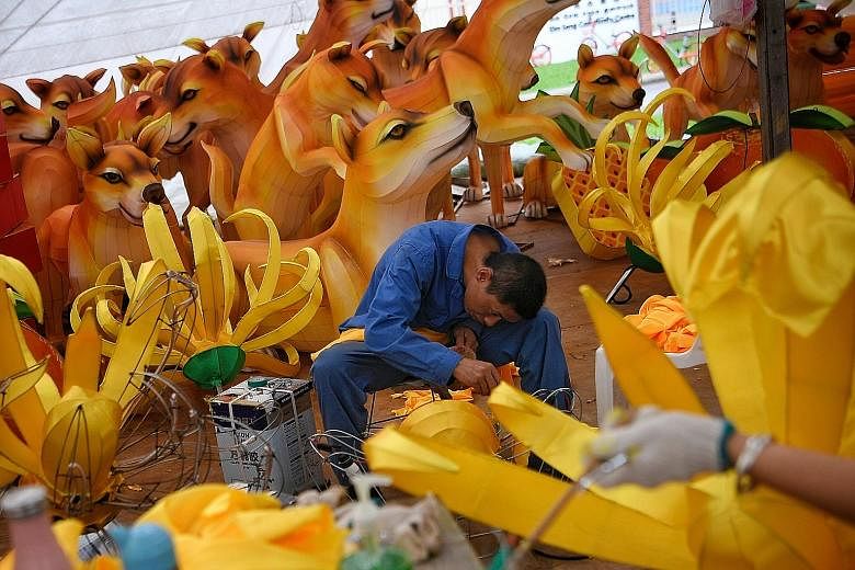 A 37-member team of craftsmen from the Zigong Zhongyi Culture Industry flew in from Sichuan late last month to begin work on giant lanterns for the Chinese New Year light-up in Chinatown to welcome the Year of the Dog. This year's design is a collabo