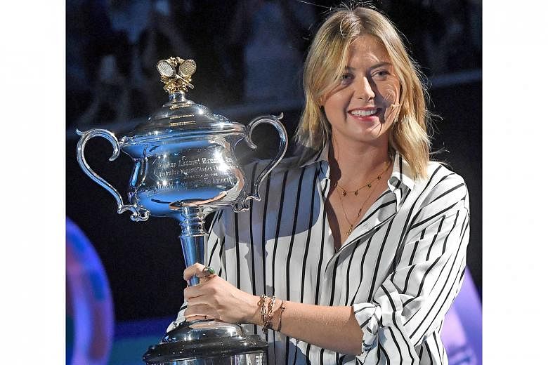The 2008 Australian Open champion Maria Sharapova carrying the Daphne Akhurst Memorial Cup into the draw ceremony. The Russian's presence at the draw yesterday was controversial given her tainted past.