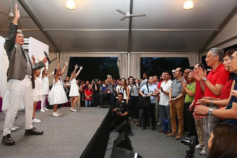Singer-songwriter Dick Lee performing the Asean theme song Rise at the Experience Asean festival yesterday. Watching the performance are (from right) Senior Minister of State Maliki Osman, Minister in the Prime Minister's Office Josephine Teo, Prime 