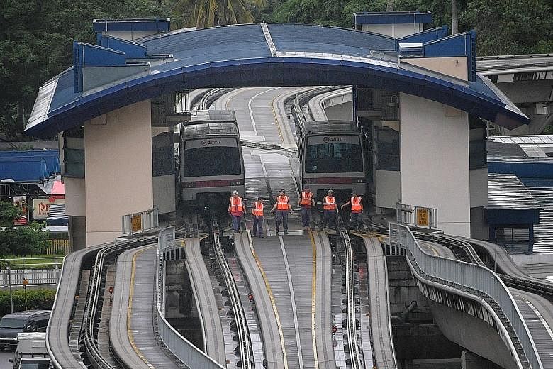 SMRT staff inspecting the tracks of the Bukit Panjang LRT yesterday after the incident. A systemwide safety check was conducted to determine whether other parts of the LRT system had also been damaged. The LRT service resumed at 6.30pm.