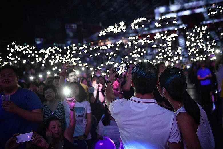 The crowd at Ed Sheeran's concert at the Singapore Indoor Stadium last November. Five foreigners have since been jailed over the use of forged passes for the British singer's concerts, which took place on Nov 11 and 12.