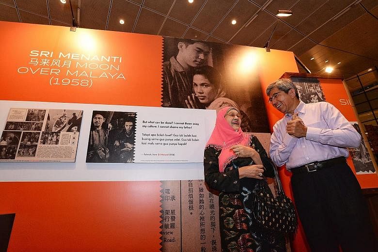 Dr Yaacob Ibrahim, Minister for Communications and Information, with veteran actress Zaiton Abdullah, 80, who starred in Sri Menanti (background), at the opening of the State Of Motion series at the National Library Building yesterday.