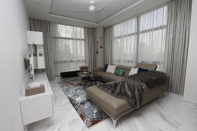Marble flooring (top) gives the apartment of Ms Rashi Tulshyan and Mr Rahul Daswani (above) a luxe feel. The kitchen, which adjoins the dining area (left), is fitted with cabinetry from Ikea. An earthy palette gives this bedroom (above) a warm and co