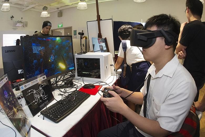A student trying out augmented reality at Ngee Ann Polytechnic's School of InfoComm Technology. Polytechnics are more suited to those who enjoy hands-on learning.