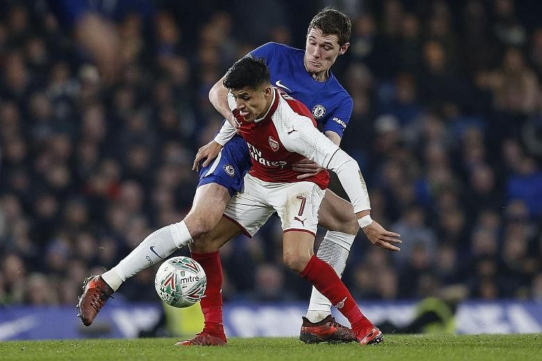 Arsenal forward Alexis Sanchez tussling with Chelsea defender Andreas Christensen during the first leg of their League Cup semi-final on Wednesday. The Chilean looks set to end his stay at the Emirates, with Manchester City and Manchester United both