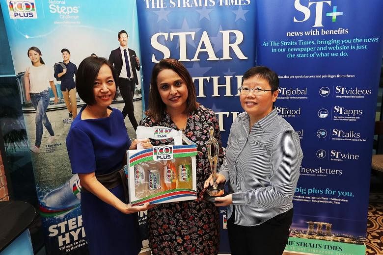 ST sports editor Lee Yulin (right) and F&N Foods general manager Jennifer See presenting December's ST Star of the Month award to Uma Berthier, who accepted it on behalf of her daughter, national fencer Amita Berthier. Amita is in Poland for a compet