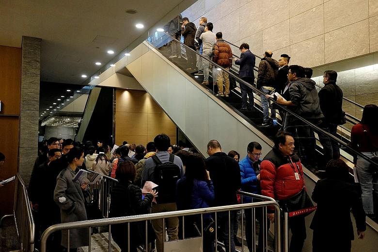 Hundreds queued up to buy Sun Hung Kai Properties' flats, the least expensive of which, at 382 sq ft, was being sold at about $1.36 million, in Hong Kong yesterday.