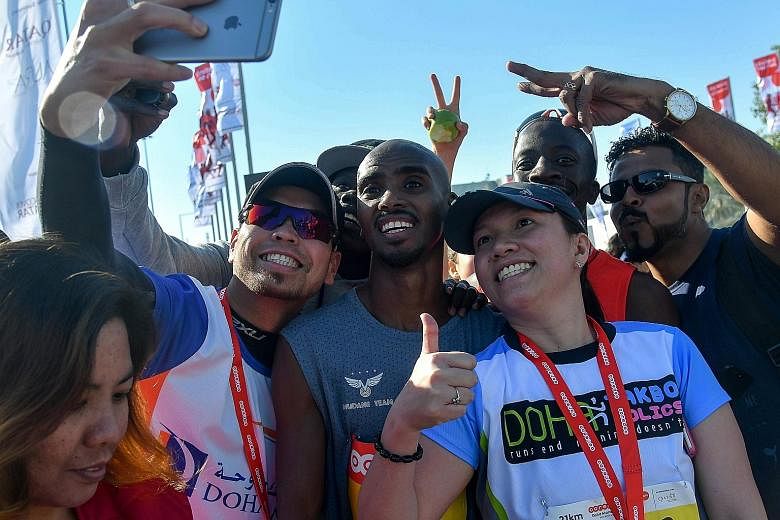 Mo Farah showing (Mobot) love to the spectators after his 10,000m victory at the 2016 Rio Olympics. Four-time Olympic gold medallist Mo Farah (centre) posing for photographs on Friday after the annual Doha Marathon in Qatar. The Briton plans to compe