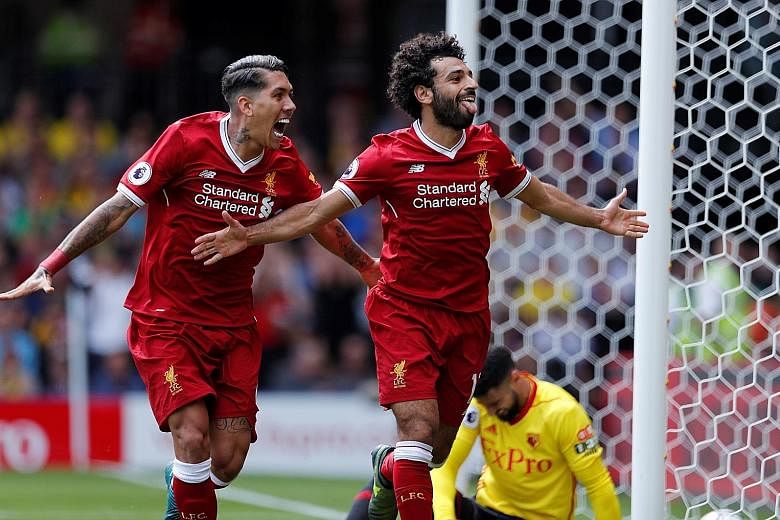 Liverpool's Mohamed Salah (right) and Roberto Firmino, together with Sadio Mane (not pictured), will need to step up for the Reds' attack today if they hope to end Manchester City's unbeaten streak in the Premier League.