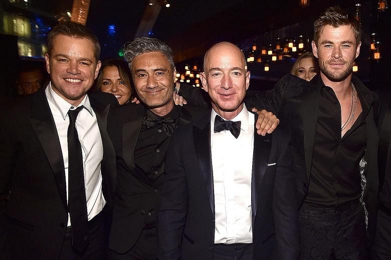 Amazon founder Jeff Bezos (second from right) with (from left) actor Matt Damon, director Taika Waititi and actor Chris Hemsworth at Amazon Studios' Golden Globes Celebration in California earlier this month.