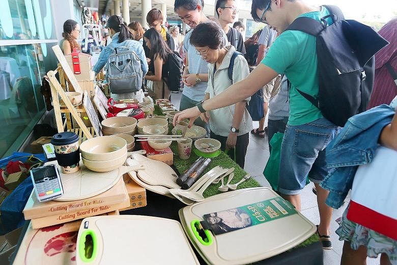 Visitors to booths could buy items such as locally grown organic produce (above) and tableware made from rice husks (far left); or learn about self-contained raised garden beds which are ideal for urban vegetable and herb gardening.