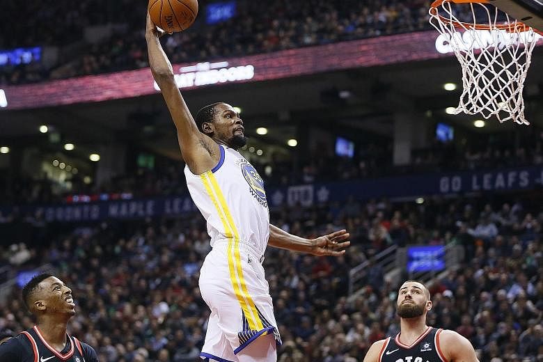 Golden State Warriors forward Kevin Durant soars for a dunk against the Toronto Raptors at the Air Canada Centre on Saturday.