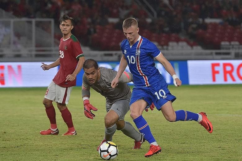 Iceland midfielder Albert Gudmundsson gets past Indonesian goalkeeper Andritany Ardhiyasa in a friendly in Jakarta yesterday. Iceland won the match 4-1.