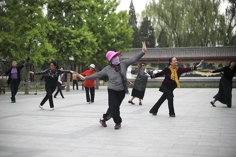 Women going through their square dancing routine at a park in Beijing. The activity is now so popular that it has even been considered a sport, and its participants, mostly middle-aged and elderly Chinese women, have been described as "walking wallet