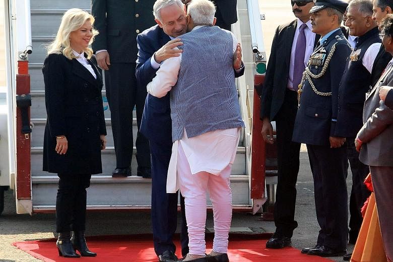 Indian PM Narendra Modi welcoming Israeli PM Benjamin Netanyahu and his wife Sarah upon their arrival at the airport in New Delhi yesterday.