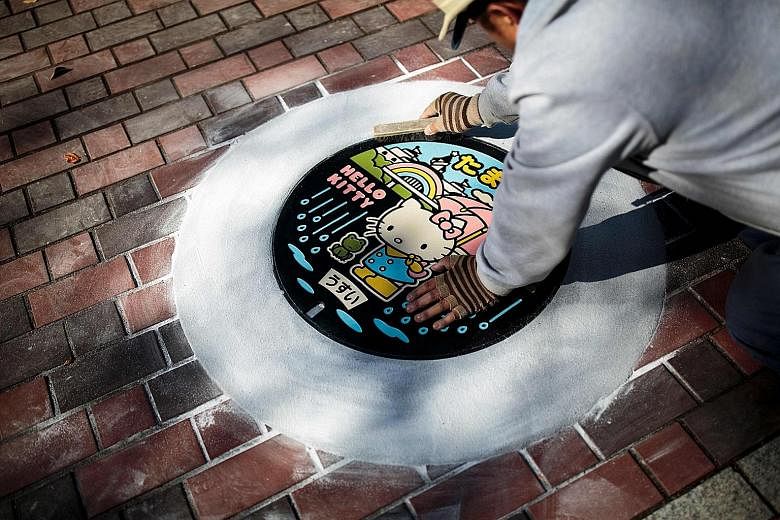 Above: Specially designed manhole covers in Kawaguchi in Japan's Saitama prefecture. Left: Hello Kitty adorns a manhole cover in Tama, which has a theme park featuring the much-loved Sanrio character.