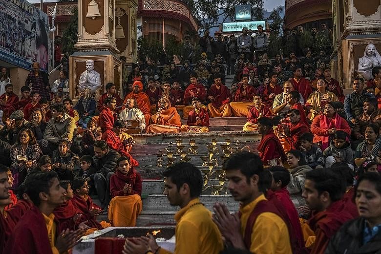 (Above) Religious students and tourists during a nightly ritual at the Parmath Niketan ashram in Rishikesh, India; and a meditation pod (right) on the roof of the ashram formerly run by Maharishi Mahesh Yogi, where The Beatles had stayed in 1968.