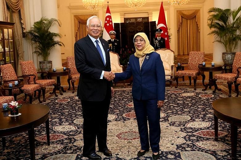 Malaysian Prime Minister Najib Razak calling on President Halimah Yacob at the Istana yesterday for the first time since she took office.