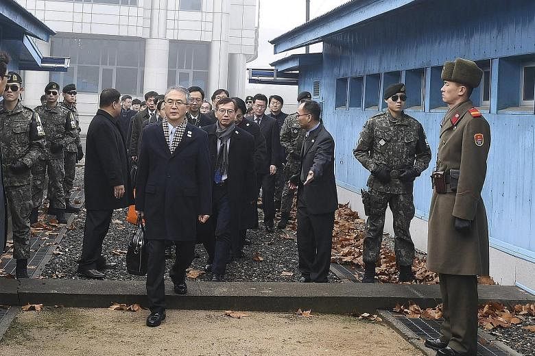 South Korean chief delegate Lee Woo Sung leading his team to the North Korean side of the border, in the truce village of Panmunjom, for a meeting on the Winter Olympics yesterday.
