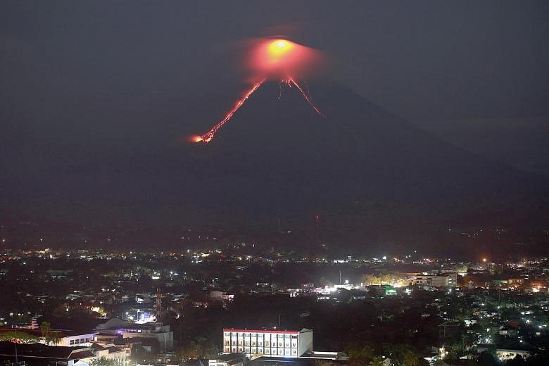 Philippine volcano's lava fireworks draw tourists as residents flee ...