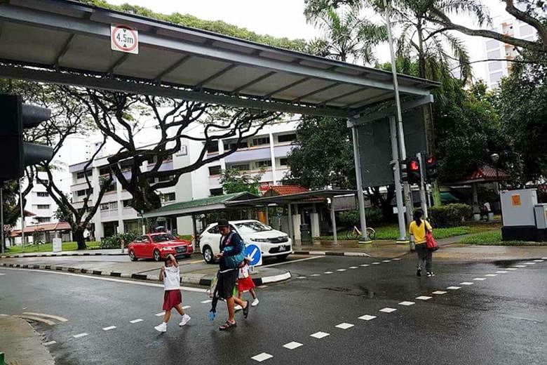 The pedestrian crossing and the shelter not in alignment (left) and the crossing now shifted under the shelter (right), at the entrance of Rulang Primary School in Jurong West Street 52. The photo showing the misalignment had gone viral on Facebook l