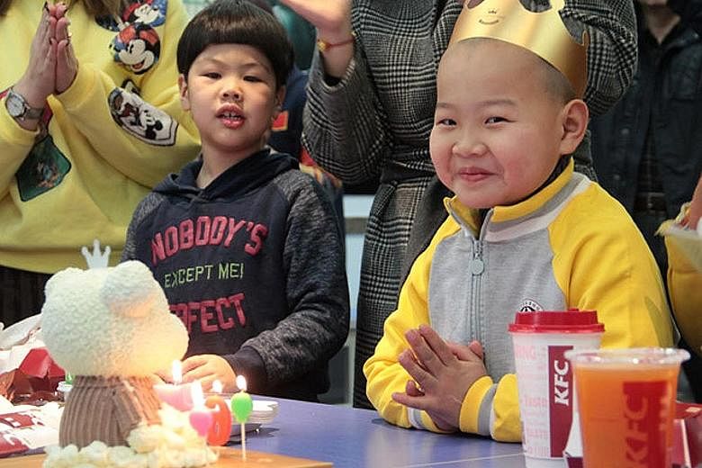 The boy (right), nicknamed Xiaochangjiang, which means "Little Yangtze River", celebrating his birthday for the first time on Sunday at a welfare home in Qingdao, Shandong province.