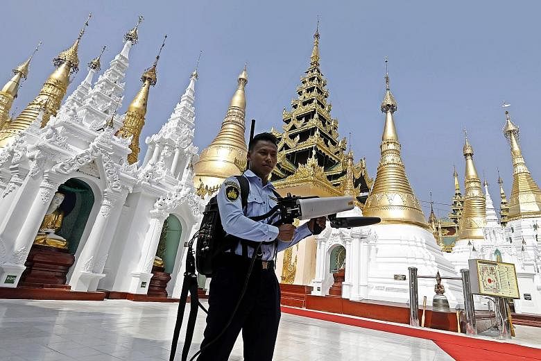A security officer at the Shwedagon Pagoda in Yangon, Myanmar, carrying an anti-drone gun during the visit of Laotian Prime Minister Thongloun Sisoulith and his wife yesterday. Mr Thongloun and his delegation were on a two-day visit to Myanmar, the L