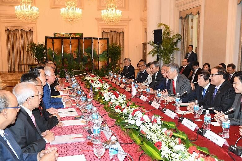 Prime Minister Lee Hsien Loong, along with other Singapore leaders, meeting his Malaysian counterpart Najib Razak and other Malaysian leaders during the retreat yesterday.