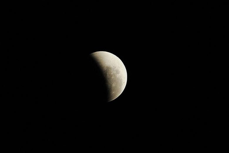 A photograph of the occurrence of a total lunar eclipse, shot at 11.45pm on Dec 10, 2011. On Jan 31, Singaporeans will get to see the rare coincidence of the blood moon, blue moon and supermoon phenomena - a total lunar eclipse, the second full moon 