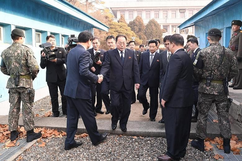 North Korean chief delegate Jon Jong Su (centre) and delegates heading to a meeting in the truce village of Panmunjom yesterday, as seen in this handout photo from the South Korean Unification Ministry. The two sides agreed to march together under a 