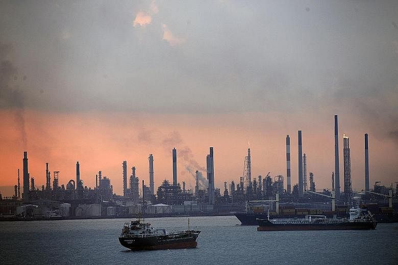 The three men were charged in connection with the theft of oil from Shell's Pulau Bukom refinery.