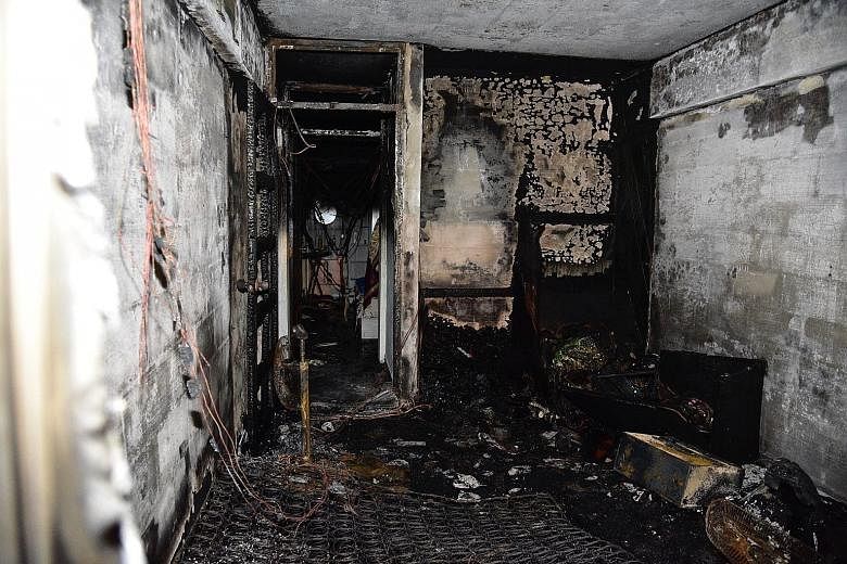 A woman in her 80s and another in her 30s were taken by ambulance to Tan Tock Seng Hospital after suffering from breathlessness. The cause of the fire in the second-floor unit (below) is being investigated. Left: The fire - seen from the front of Blo