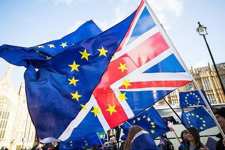Pro-Europe protesters wave flags made up of European Union and British flags outside the Houses of Parliament in London on Tuesday. Facebook plans to launch a "detailed analysis of historical data" to establish whether there was Russian interference 